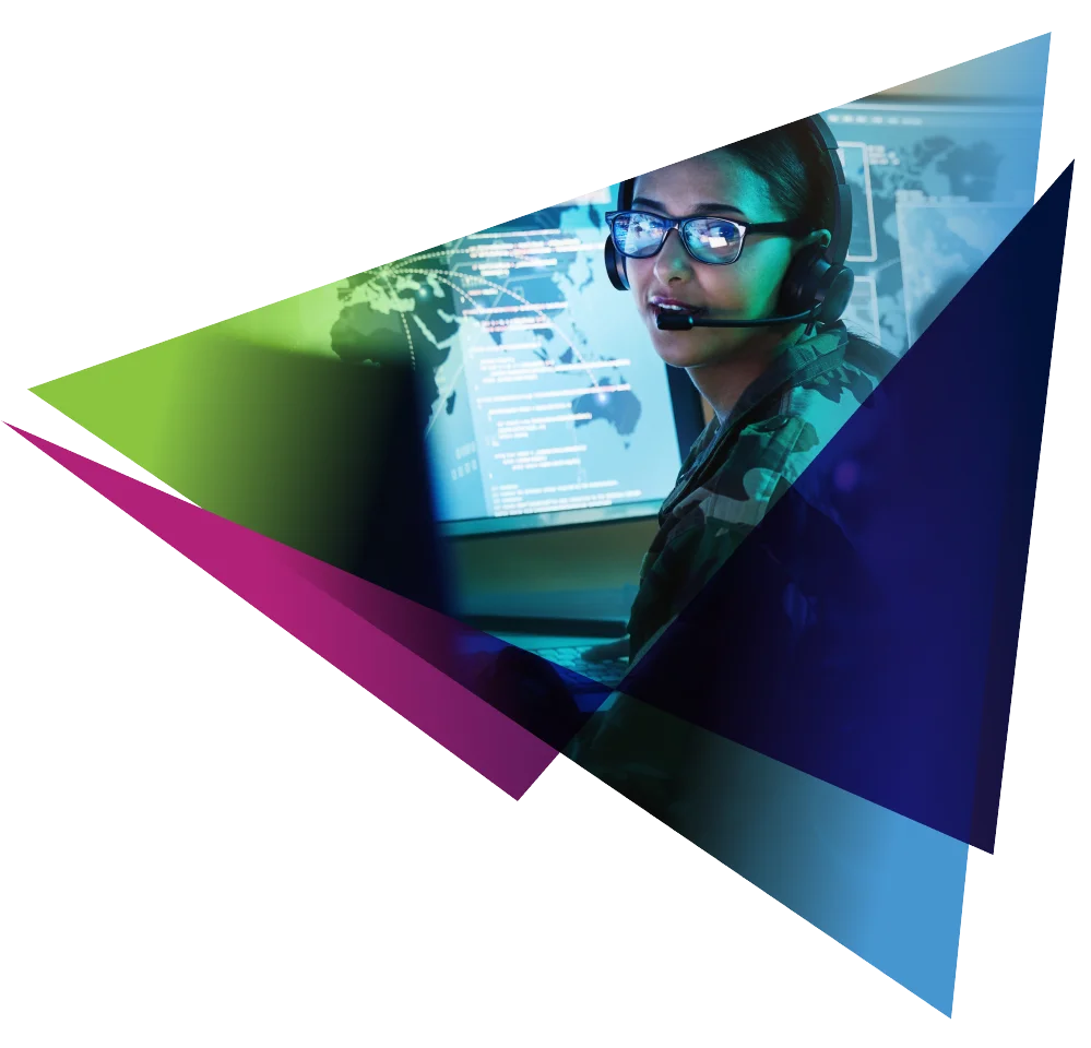 Person wearing a headset in a control room with a digital map display on screen.